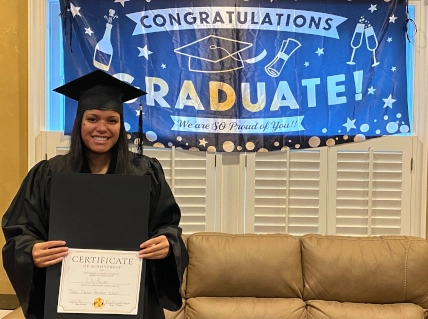 Tulsa DAS graduate proudly holding her certificate after completing the 12-week dental assistant program